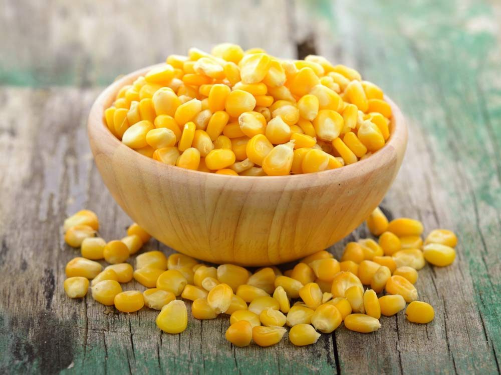Bowl of corn on wooden table