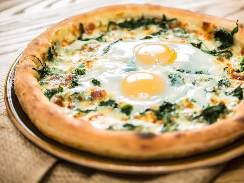 Sunny side up eggs on pizza