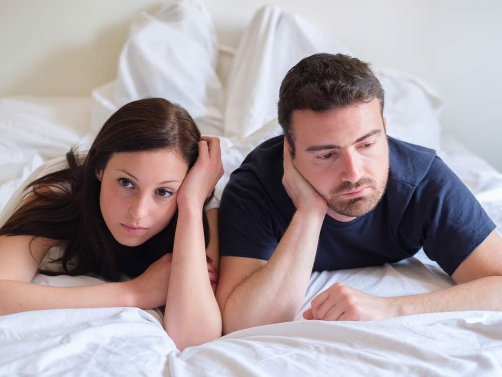 Bored lovers in bed after fight