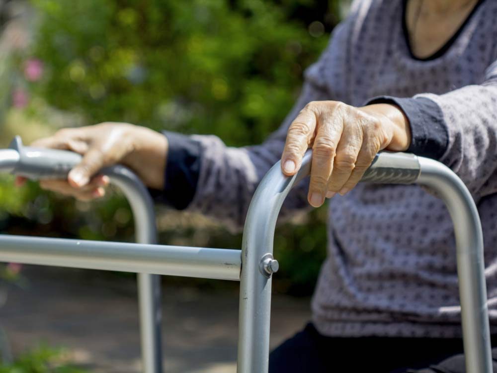 Elderly woman using walker