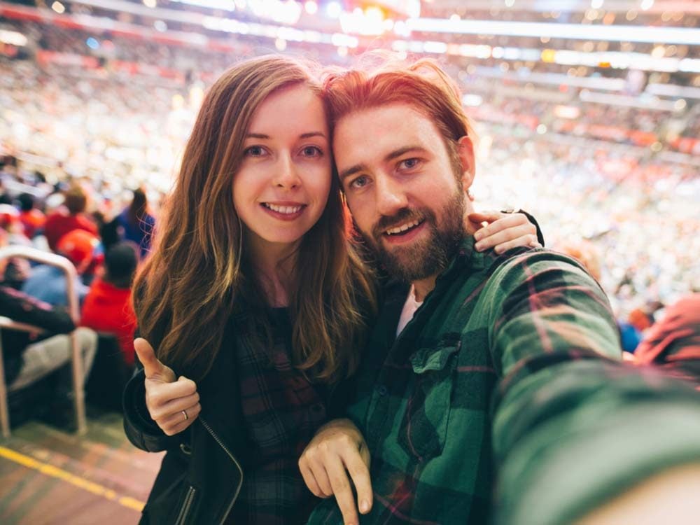 Couple taking selfie at sporting event