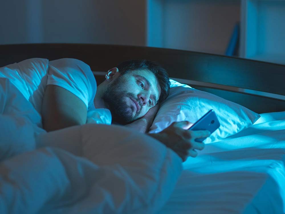 Man in bed on smartphone