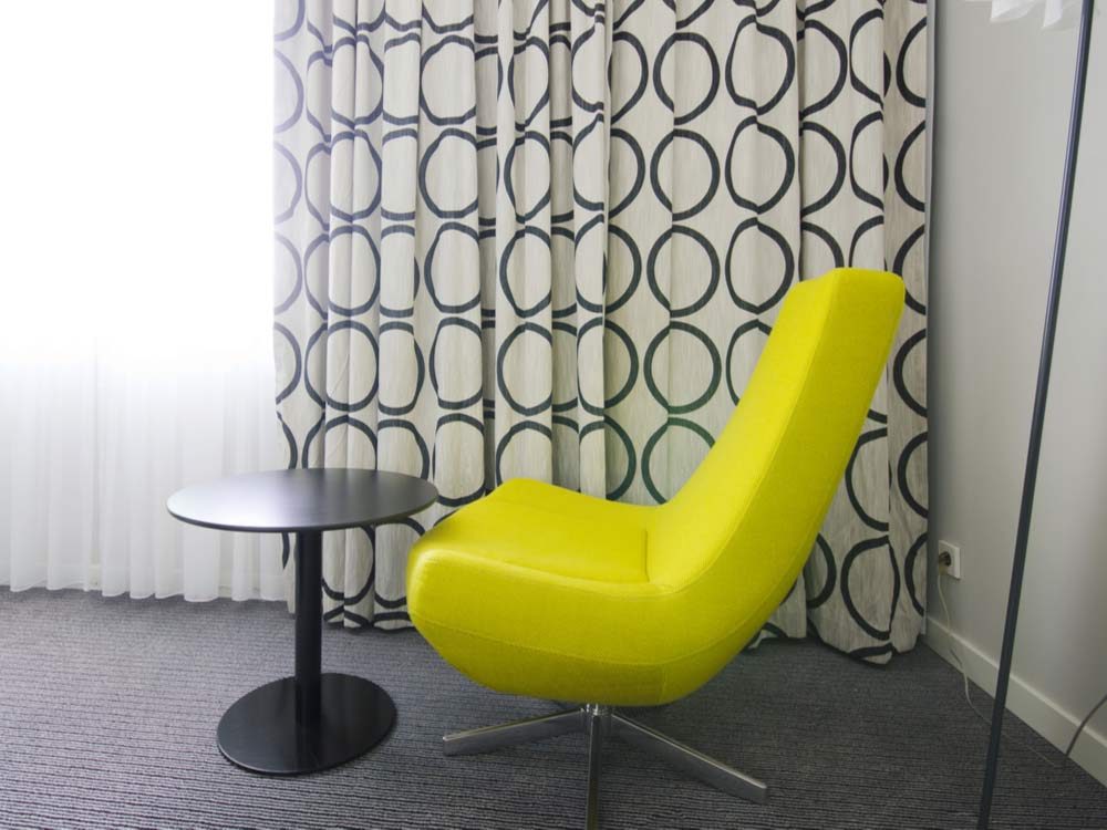 Yellow hotel chair in room
