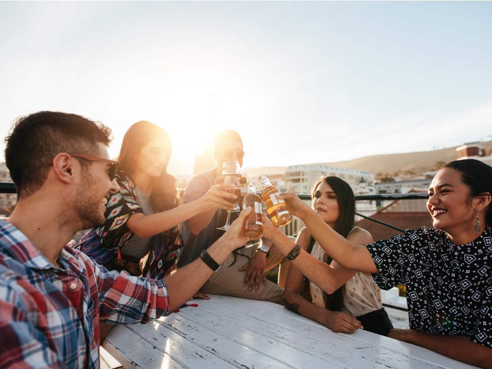 Diverse group of friends drinking on rooftop