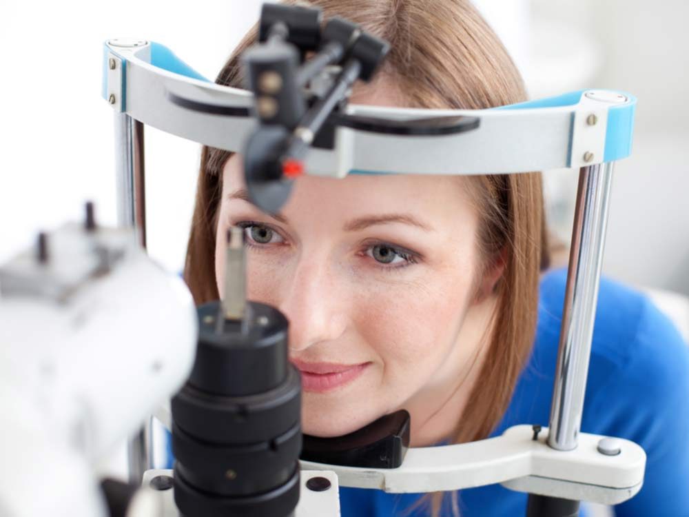 eye cataracts signs - Woman undergoing eye exam