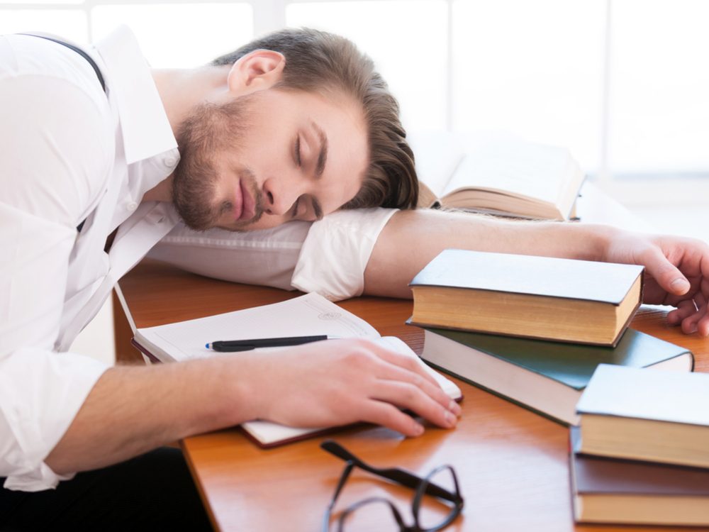 Man suffering from lack of sleep at desk