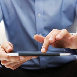 Man reading fake news on tablet