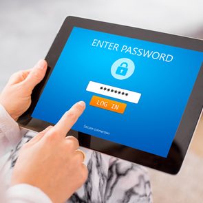 Worst passwords - woman entering password on tablet