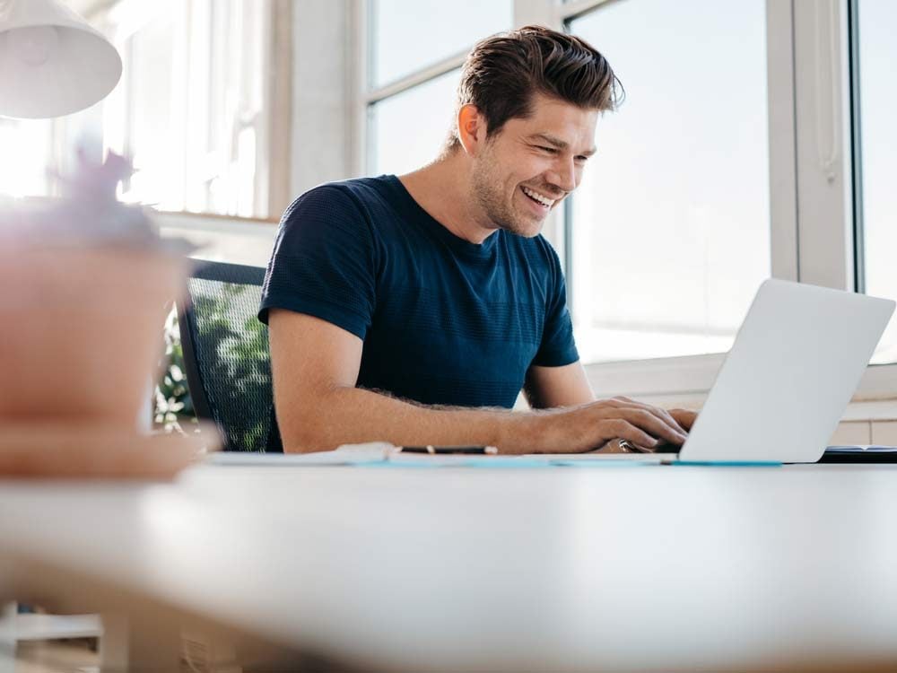 Enthusiastic man working on laptop