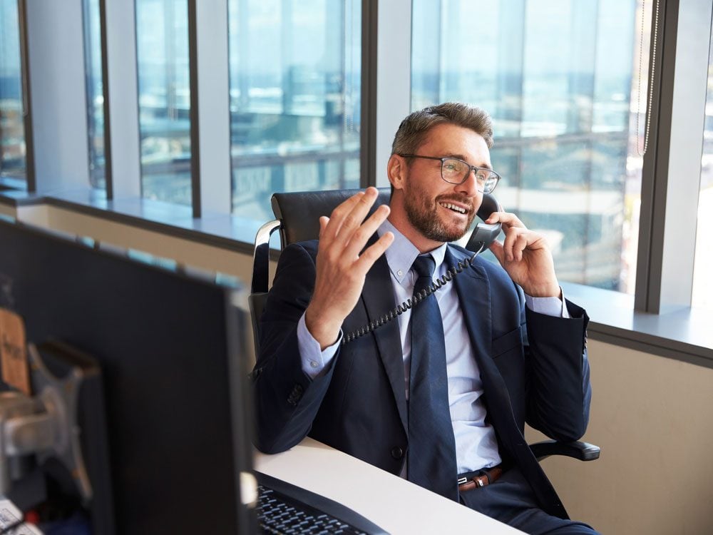 Businessman at desk talking on the phone