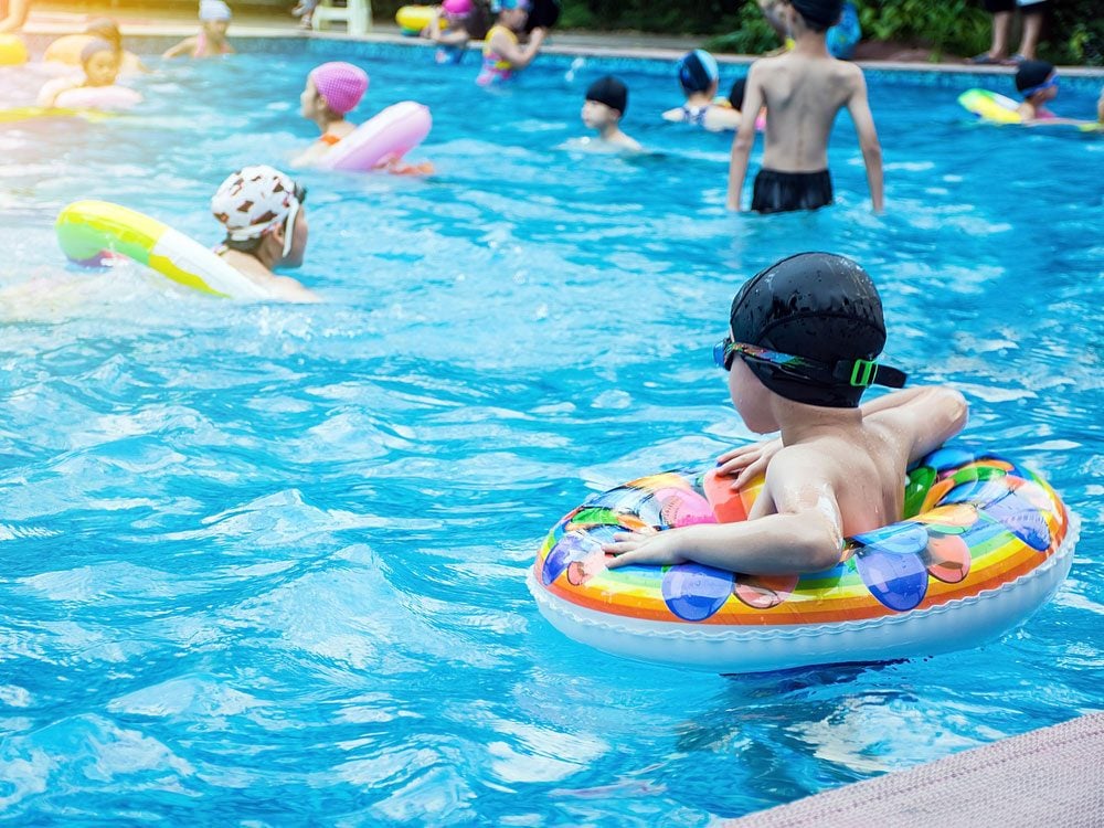 Children swimming in public pool