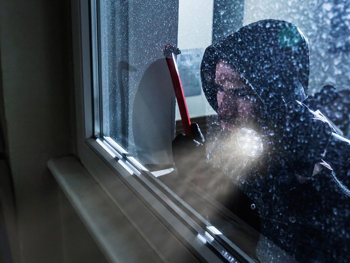 Ways burglars break in - burglar peeking in window