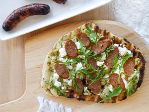 Grilled Toulouse Sausage BBQ Pizza with Goat Milk Feta and Artichoke Tapenade