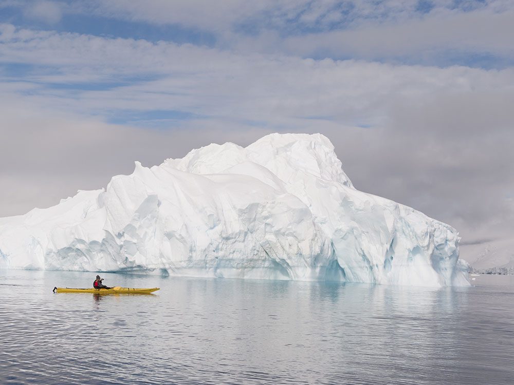 Living in Canada - kayak with iceberg