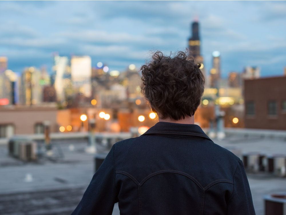 Thirtysomething man contemplating his future while looking at cityscape