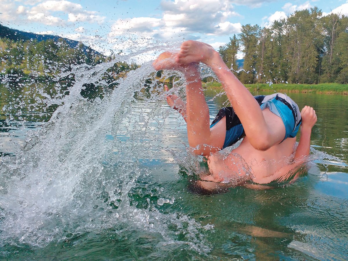 Making a splash water photography - boy splashing in lake