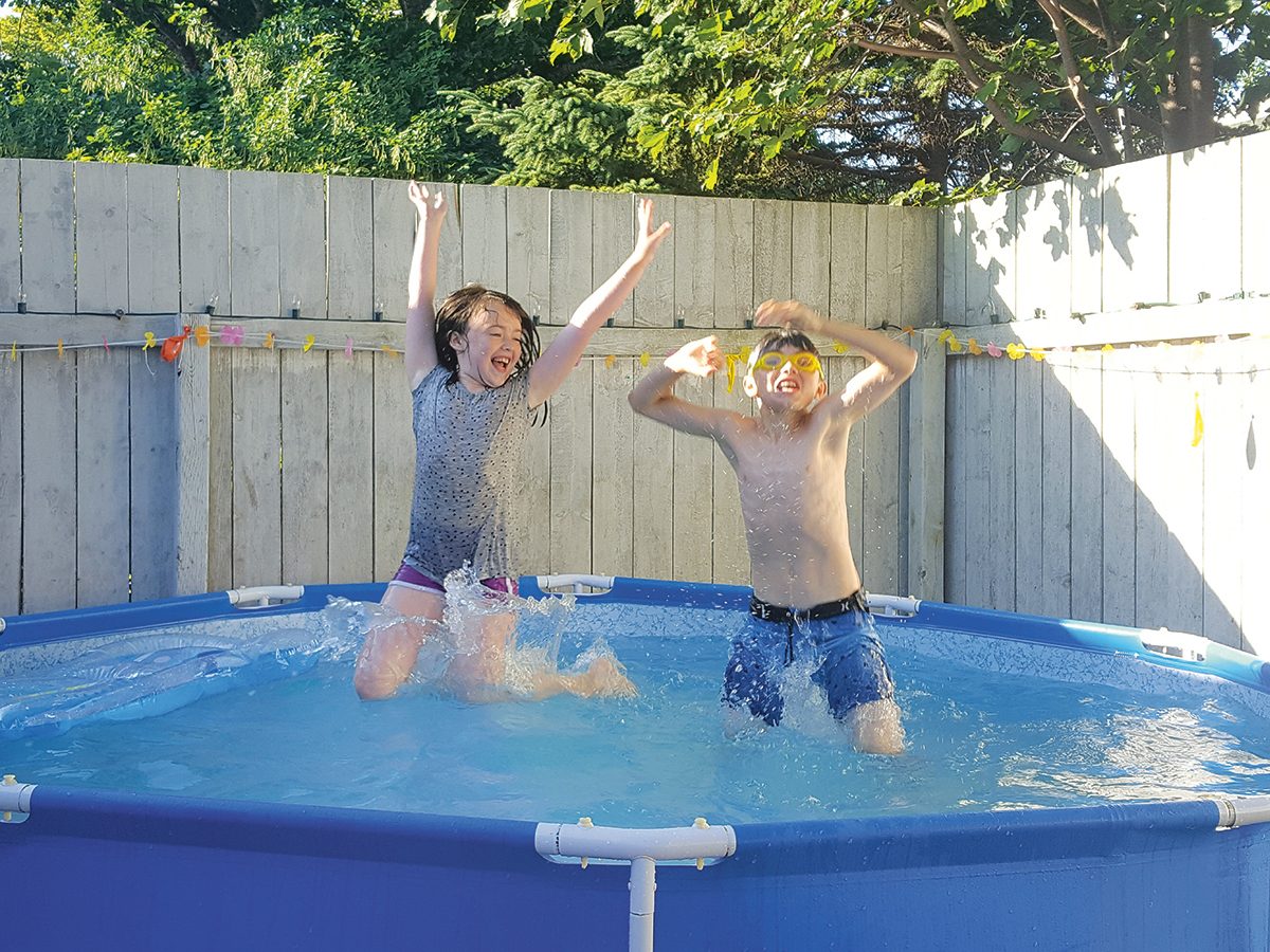 Making a splash water photography - kids in backyard pool