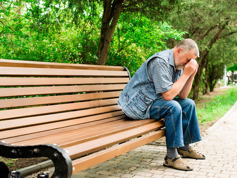 Depressed man on park bench