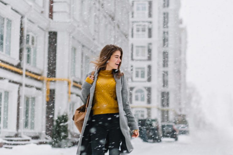 Attractive woman walking in winter street