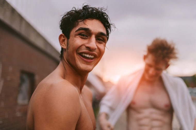 Two shirtless male friends