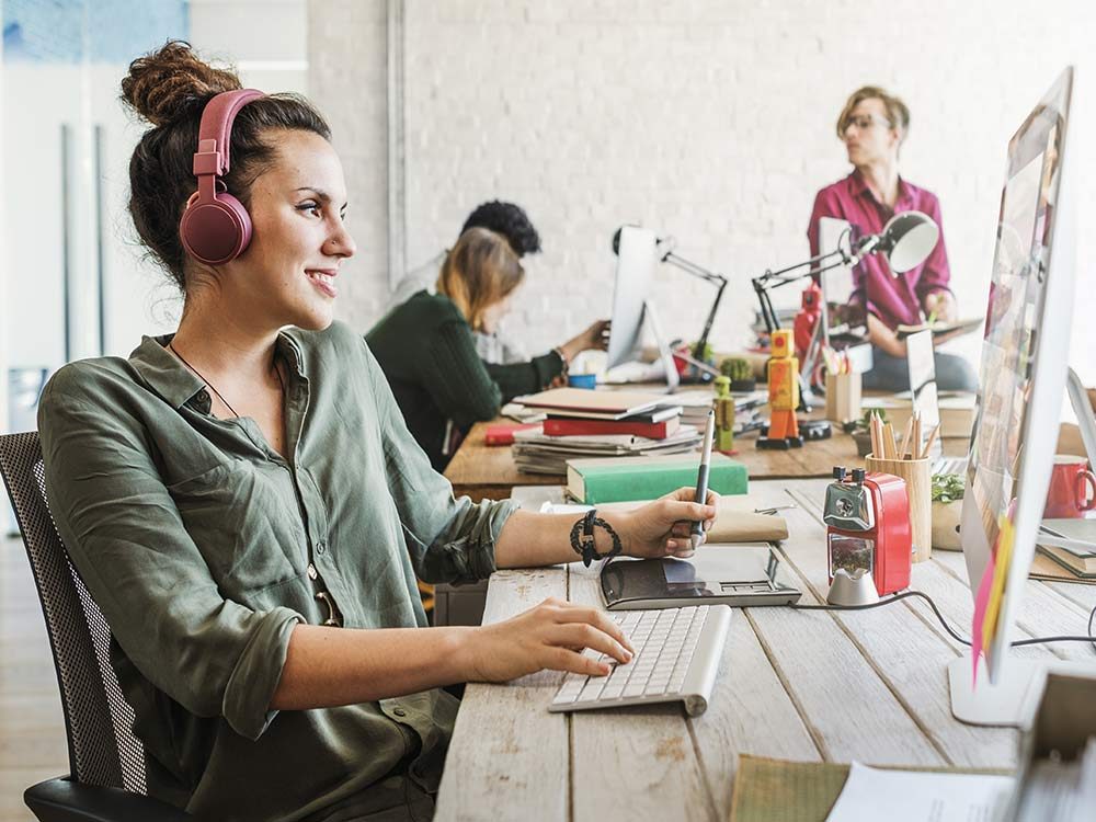 Woman with headphones at desk at work