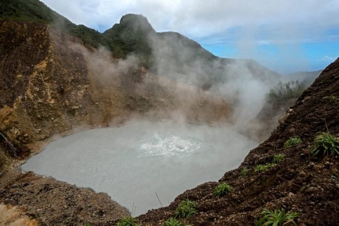 Volcanic Boiling Lake in Dominica, Caribbean Island Nation. After a rigorous hike through rain forest and Desolation Valley hiker is rewarded by a magnificent site of literally boiling lake.
