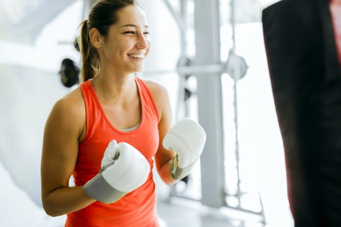 Young woman boxing and training in a gym