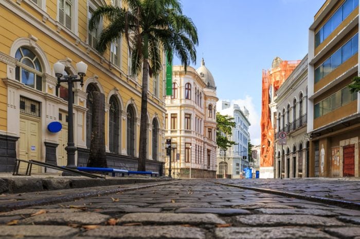 View of the historic Rua do Bom Jesus street in the city of Recife in Pernambuco, Brazil on a sunny summer day with its cobblestones and 17th century buildings.
