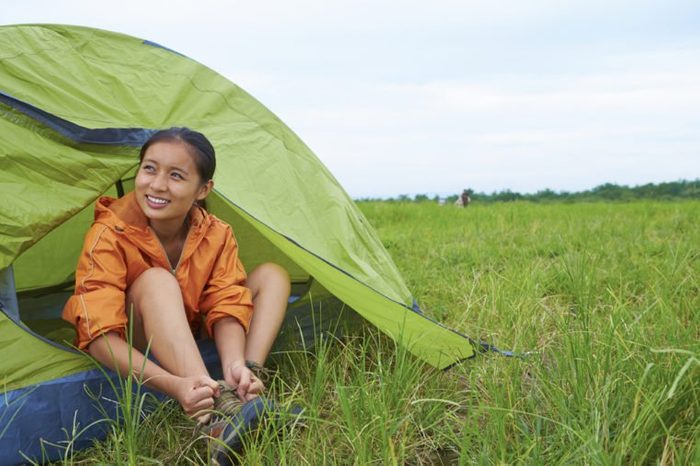 One Young Chinese Backpacker Camping Outdoor in the Nature at Summer time