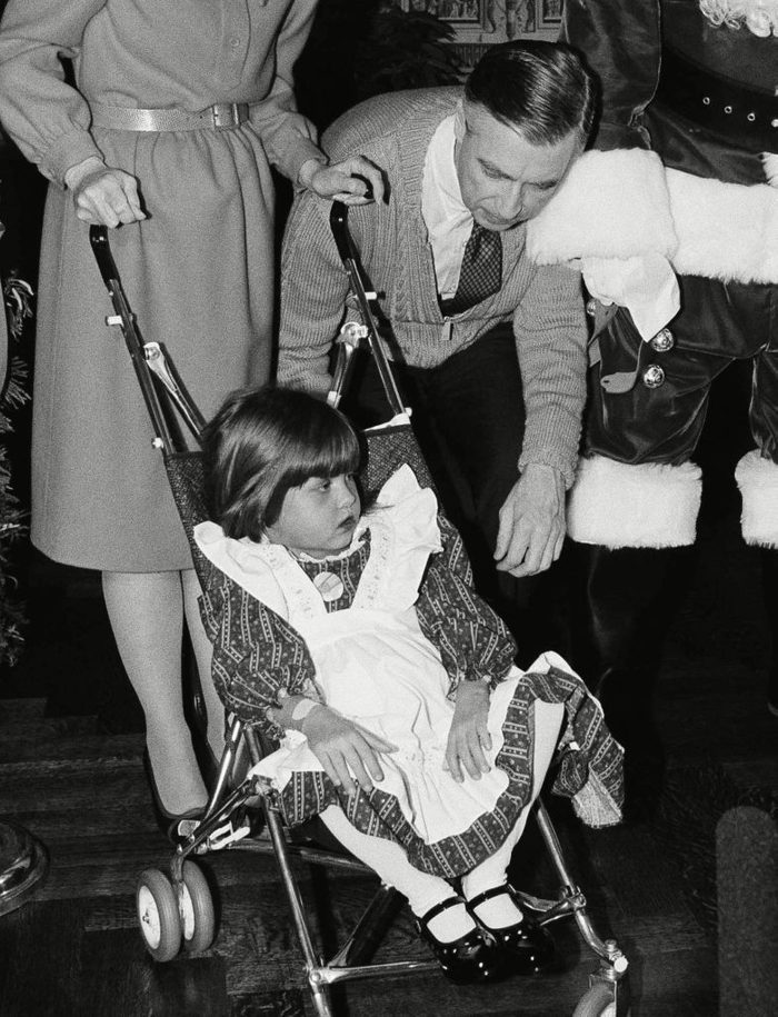 Mr. Rogers with toddler in stroller