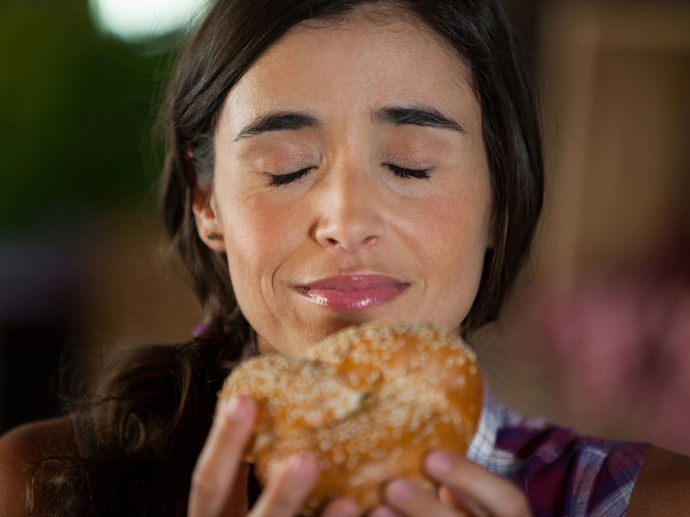 Woman smelling pastry