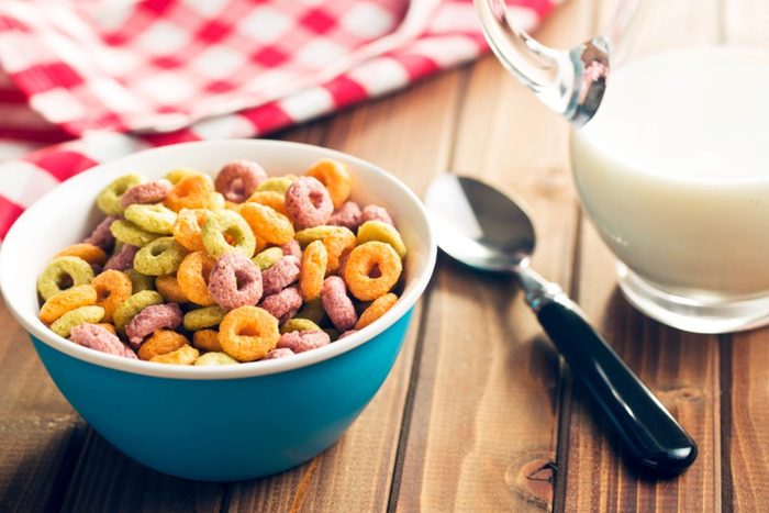 Bowl of cereal with spoon on wooden table