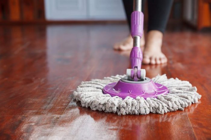 Woman cleaning floor with mop