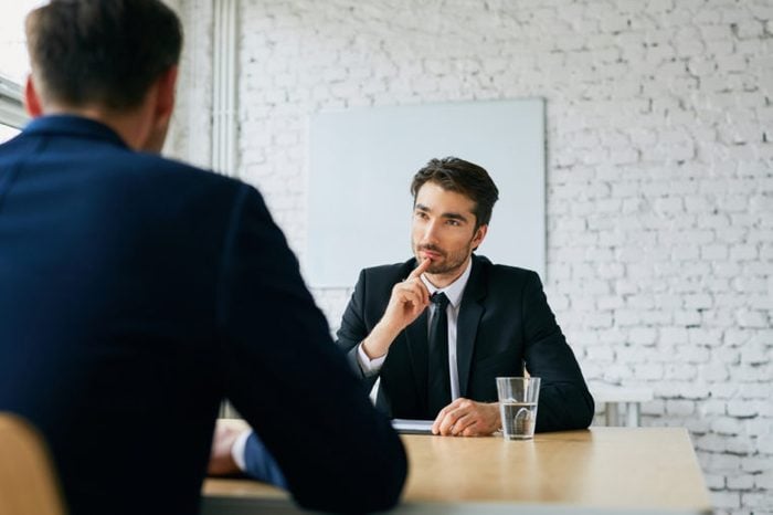 Two businessmen talking during job interview