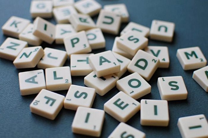 Scrabble game letters on green background.