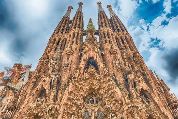 BARCELONA - AUGUST 9: The Nativity Facade of the Sagrada Familia, the most iconic landmark designed by Antoni Gaudi in Barcelona, Catalonia, Spain, as seen on August 9, 2017. Cranes digitally removed