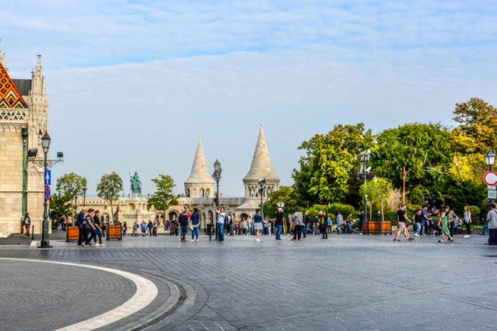 Budapest, Hungary - September 26 2017: Matthias Square with the Matthias Church and the Fisherman's Bastion with tourists enjoying the sunny day in Budapest Hungary