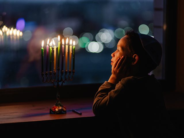Hanukkah facts - little boy and menorah