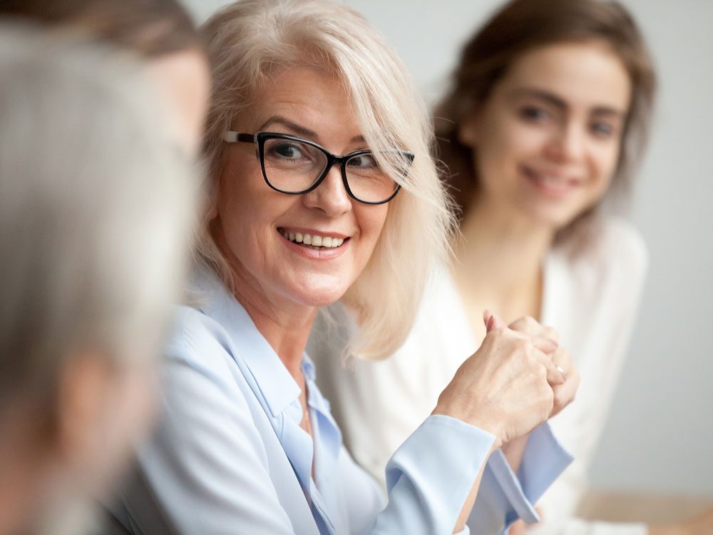 Woman smiling in business meeting