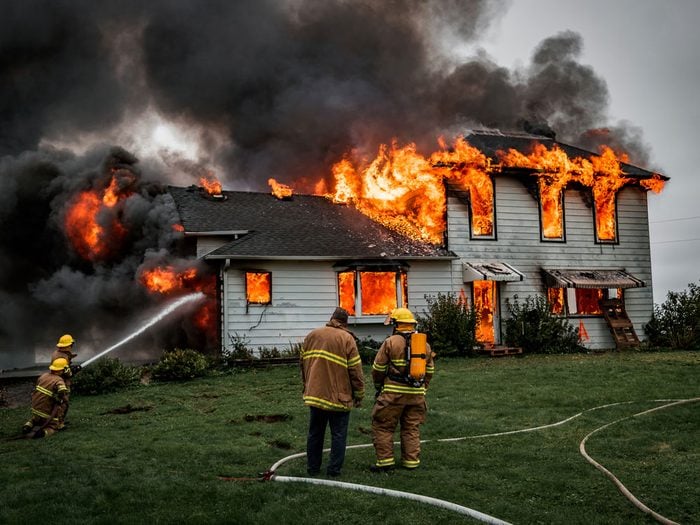 Firefighters extinguishing massive house fire