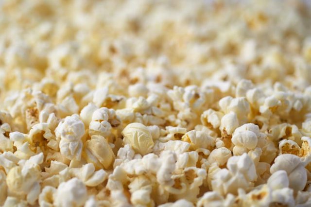 Popcorn Texture Background. Salted Popcorn Grains. Text Space