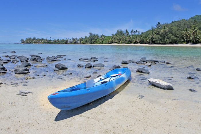 One empty blue kayak on Muri beach lagoon in Rarotonga, Cook Islands