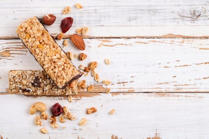 Top view of various healthy granola bars (muesli or cereal bars). Set of energy, sport, breakfast and protein bars isolated on white background
