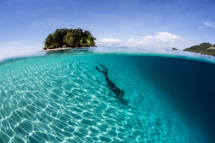A snorkeler does some free diving along a sandy slope in the Solomon Islands. This country offers incredibly diverse marine habitats, great scuba diving, and fantastic snorkeling.