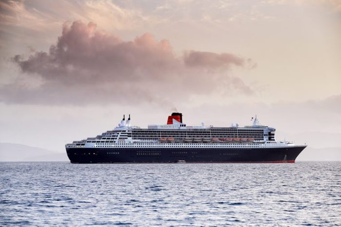 OBAN, ARGYLL AND BUTE, SCOTLAND - MAY 22, 2015: RMS Queen Mary 2, anchored off Maiden Island on May 22, 2015 in Oban, Argyll and Bute, Scotland.
