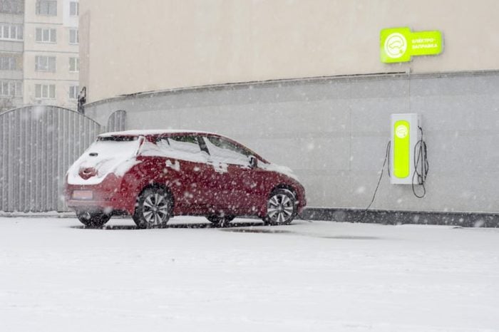 Electric car at charging in winter