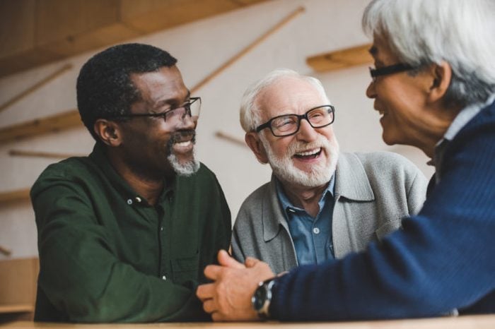 group of multiethnic senior friends spending time together and laughing