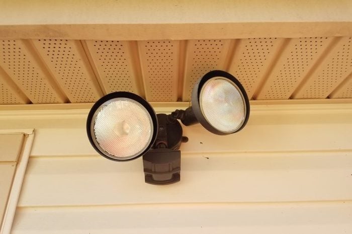 outdoor motion sensor flood light under the eaves of a house