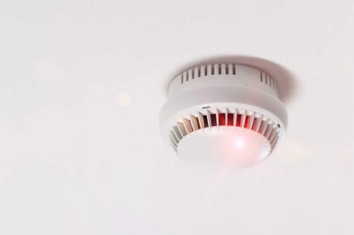 Smoke detector mounted on roof in apartment