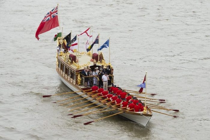 The River Pageant to Mark the Queen's offical 90th Birthday The Queen's Row Barge 'Gloriana' leads the pageant upriver